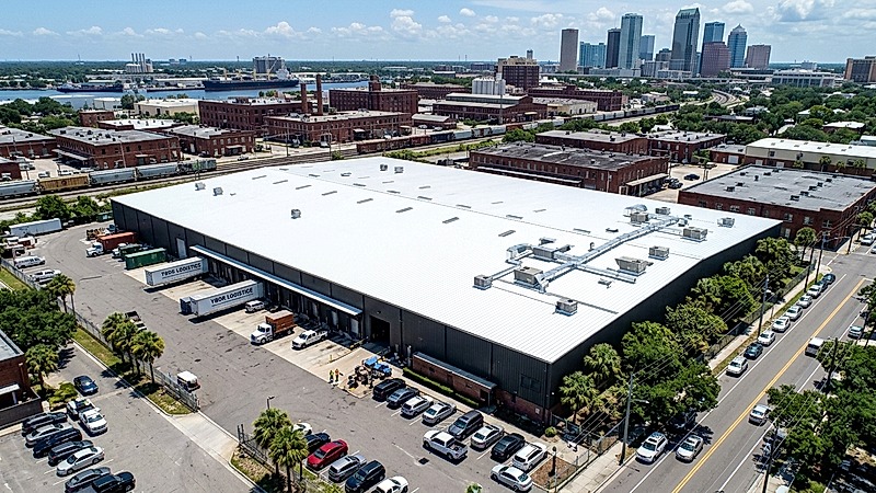 Industrial warehouse metal roof restoration with white silicone coating in Ybor City Tampa