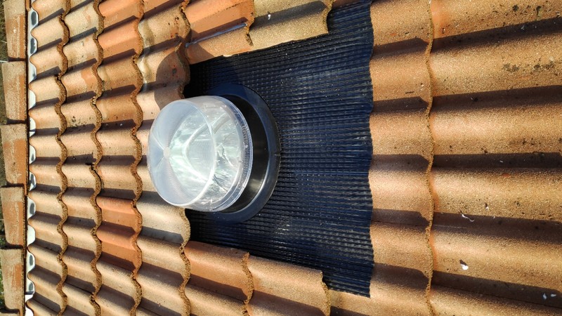 Westchase optical solar tube dome with anti-glare lens capturing low-angle sunlight on roof