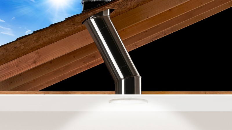 Architectural cutaway showing skylight rafter framing, roof curb flashing, and weather barrier integration