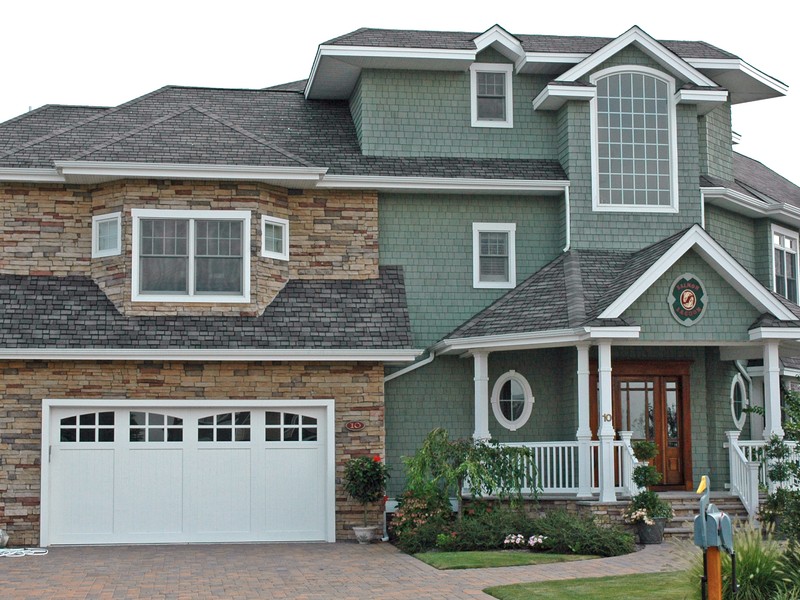 Coastal home with pristine shingle roofline and seamless gutter installation in Tampa Bay