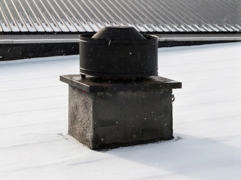 Active solar attic ventilation cap cleanly mounted to residential roof shingles in Tampa Bay